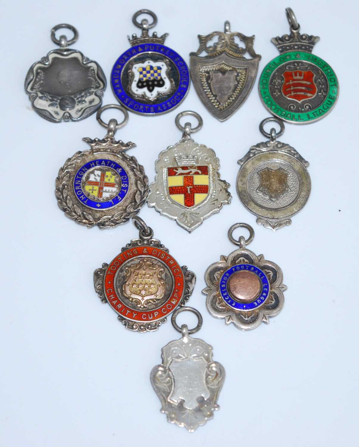 A George V silver, yellow metal and enamelled fob medal for the Tooting & District Charity