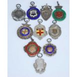 A George V silver, yellow metal and enamelled fob medal for the Tooting & District Charity