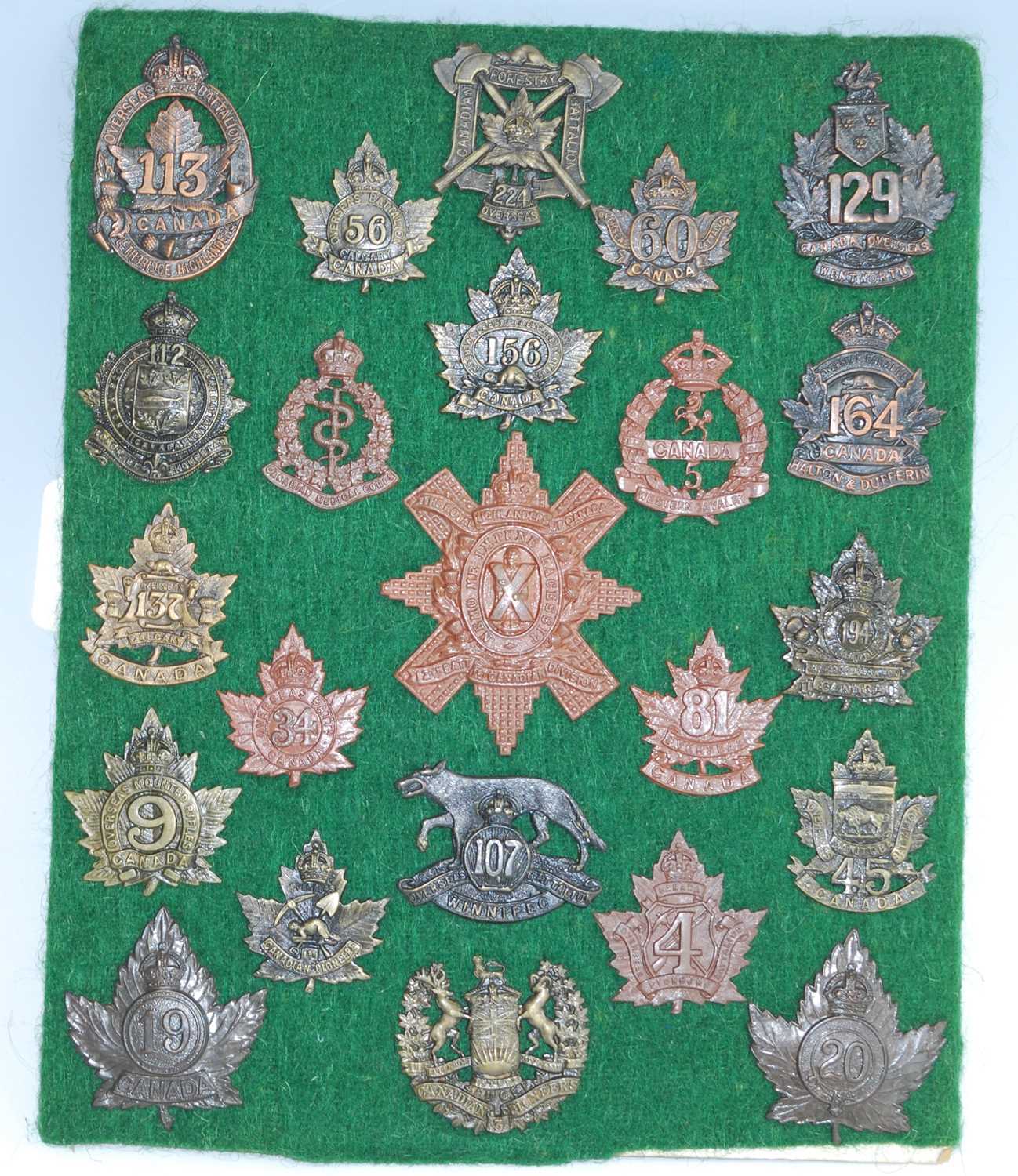 A collection of Canadian cap badges and insignia, to include 113th Battalion Lethbridge Highlanders,