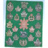 A collection of Canadian cap badges and insignia, to include 113th Battalion Lethbridge Highlanders,