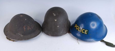 A WW II Homefront steel helmet, crudely painted to the front FAP (First Aid Party), having a leather