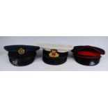 A collection of seven visor caps, various regiments to include Royal Artillery, Royal Navy, and