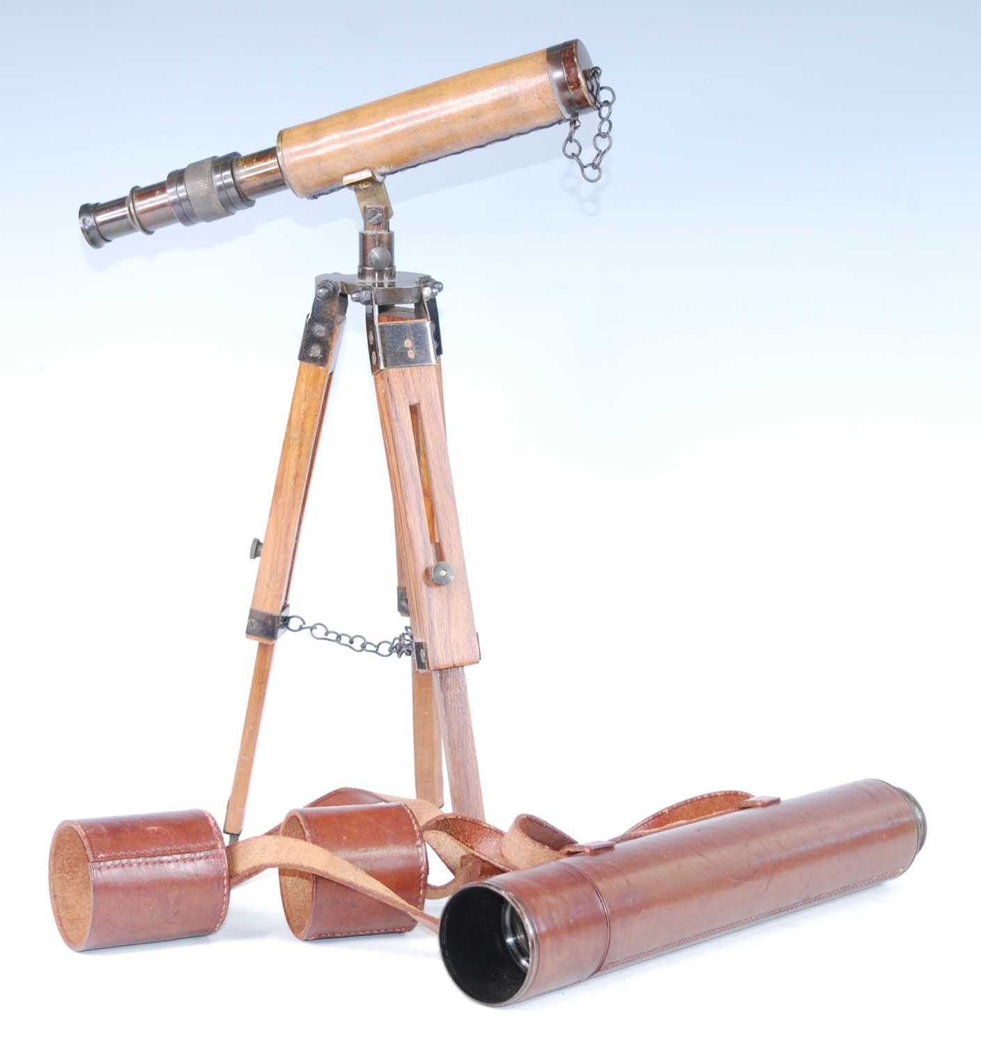 An early 20th century leather clad brass three drawer telescope, with leather lens covers, 82cm (