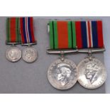 A WW II Defence and War medal pair, together with the miniature examples, one other Defence medal