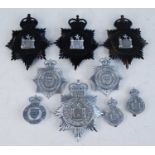 A large collection of West Suffolk Constabulary Police helmet plates and cap badges, together with