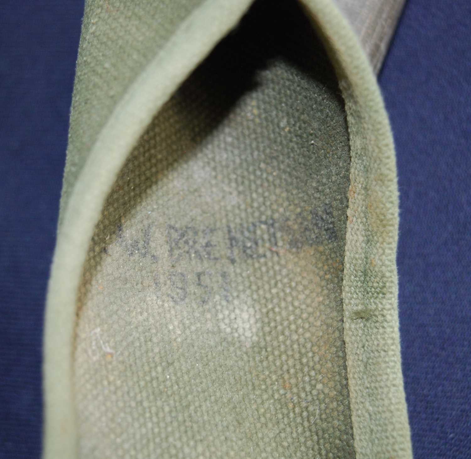 A post WW II U.S. Army entrenching axe, in webbing pouch dated 1951. - Image 2 of 2