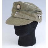 A German M43 Field cap, in green with silver piping, the front with SS totenkopf, the interior