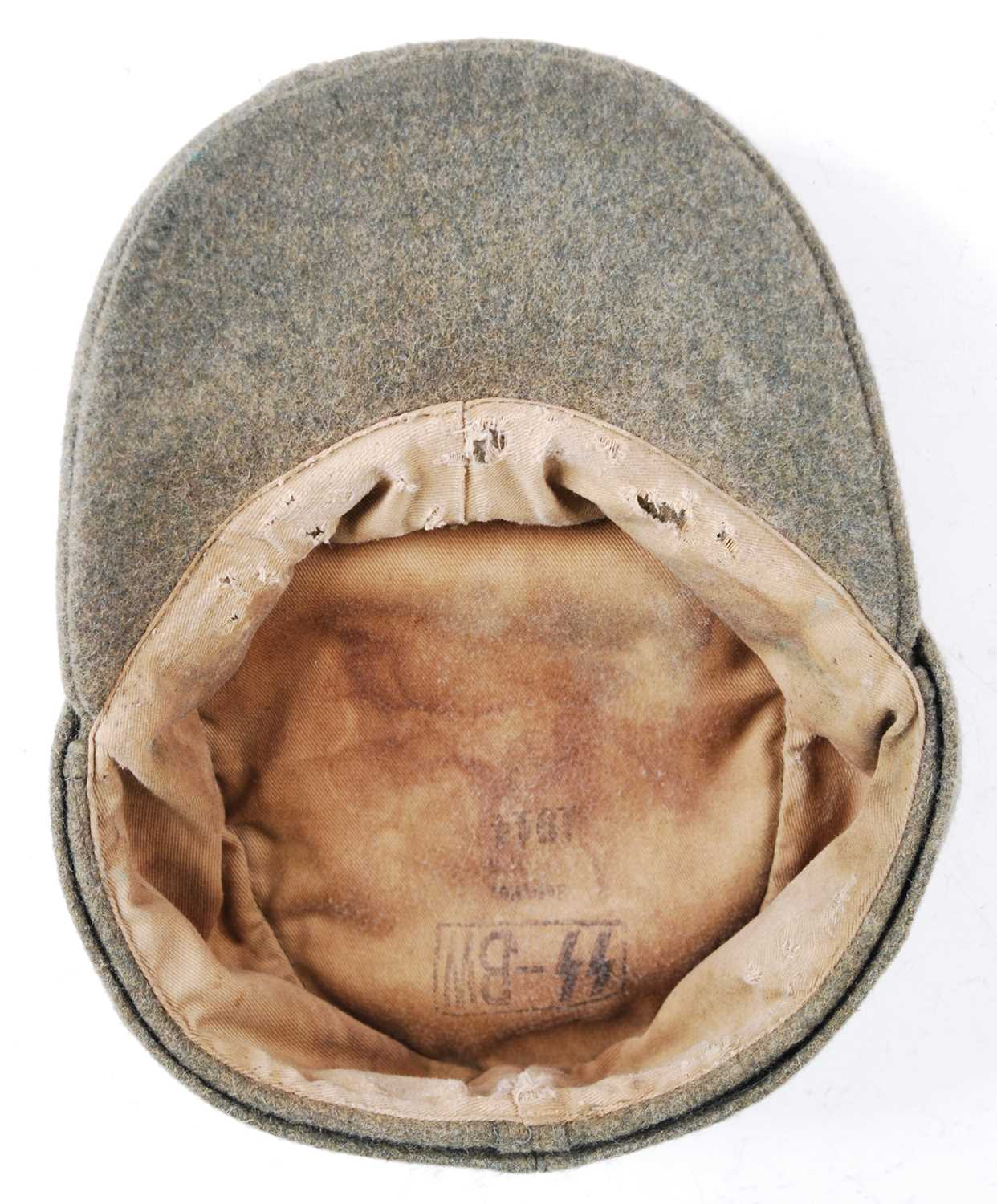 A German M43 SS Field cap, in green wool with stitched badge, the interior stamped SS-BW, dated - Image 5 of 5