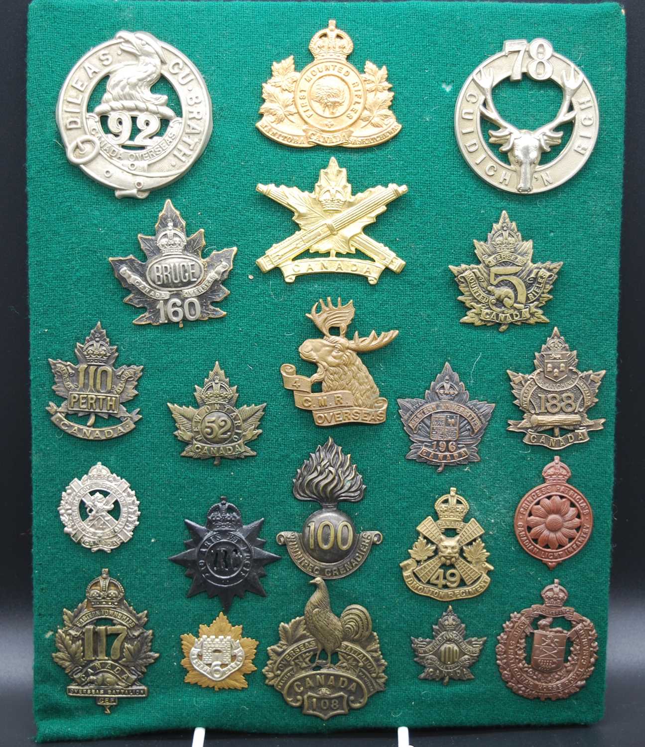 A collection of cap badges and insignia, mainly being Commonwealth Regiments to include Canadian