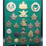 A collection of cap badges and insignia, mainly being Commonwealth Regiments to include Canadian