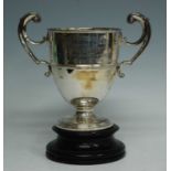 An Edwardian silver trophy cup, the body with a central band and twin c-scroll handles, engraved "