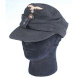 A German M43 Field cap, in black with Luftwaffe badge, stamped to the interior Weber & Ott and dated