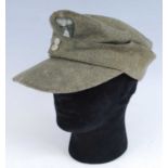 A German M43 SS Field cap, in green wool with stitched badge, the interior stamped SS-BW, dated