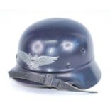 A German Luftschutz Civil Defence helmet, with leather liner and chin strap, stamped to the interior