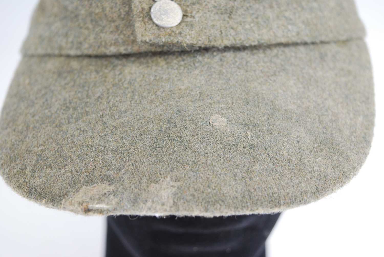 A German M43 SS Field cap, in green wool with stitched badge, the interior stamped SS-BW, dated - Image 3 of 5