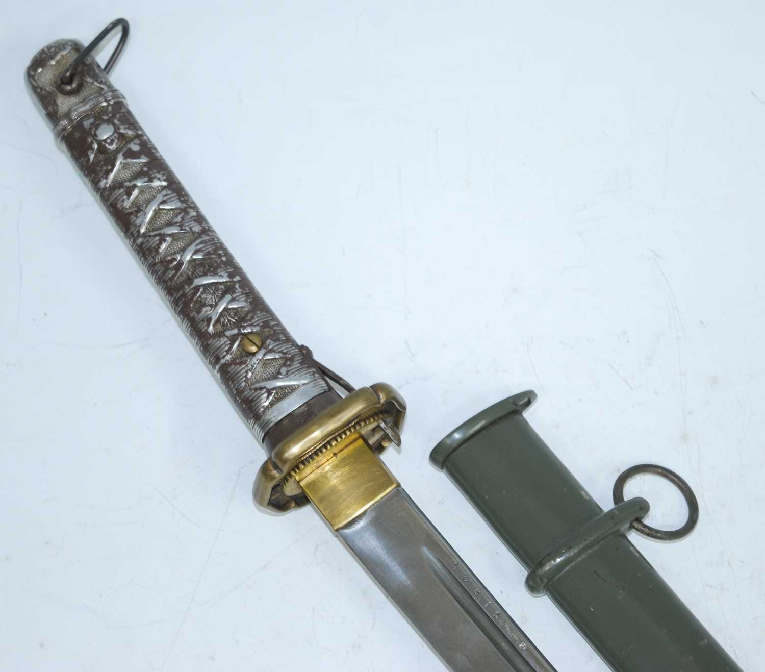 A Japanese shin gunto katana, having a 67cm single edged fullered blade numbered 50815, gilt metal