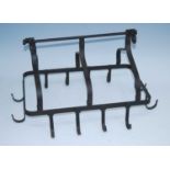 A wrought iron game hook, having a horizontal hanging bar with three folding arched divisions