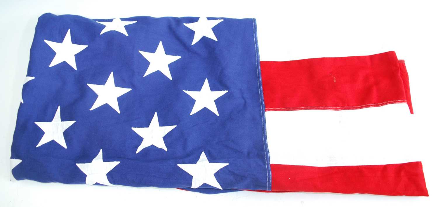 A large American Stars and Stripes flag of stitched cotton construction, having fifty stars, stamped