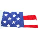 A large American Stars and Stripes flag of stitched cotton construction, having fifty stars, stamped