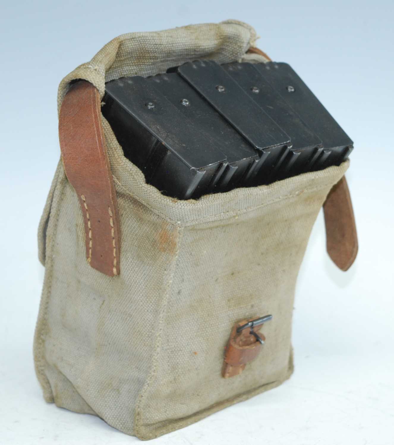 A WW II canvas and brown leather magazine pouch, containing five Bren gun magazines.