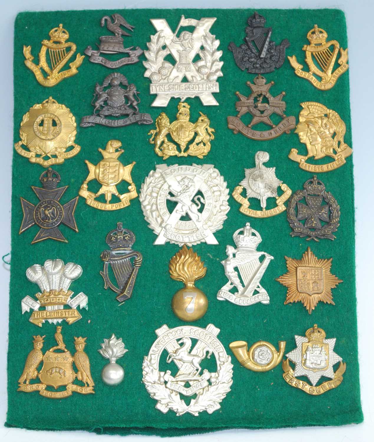 A collection of British Army cap badges and insignia to include Tyneside Irish, 10th County of