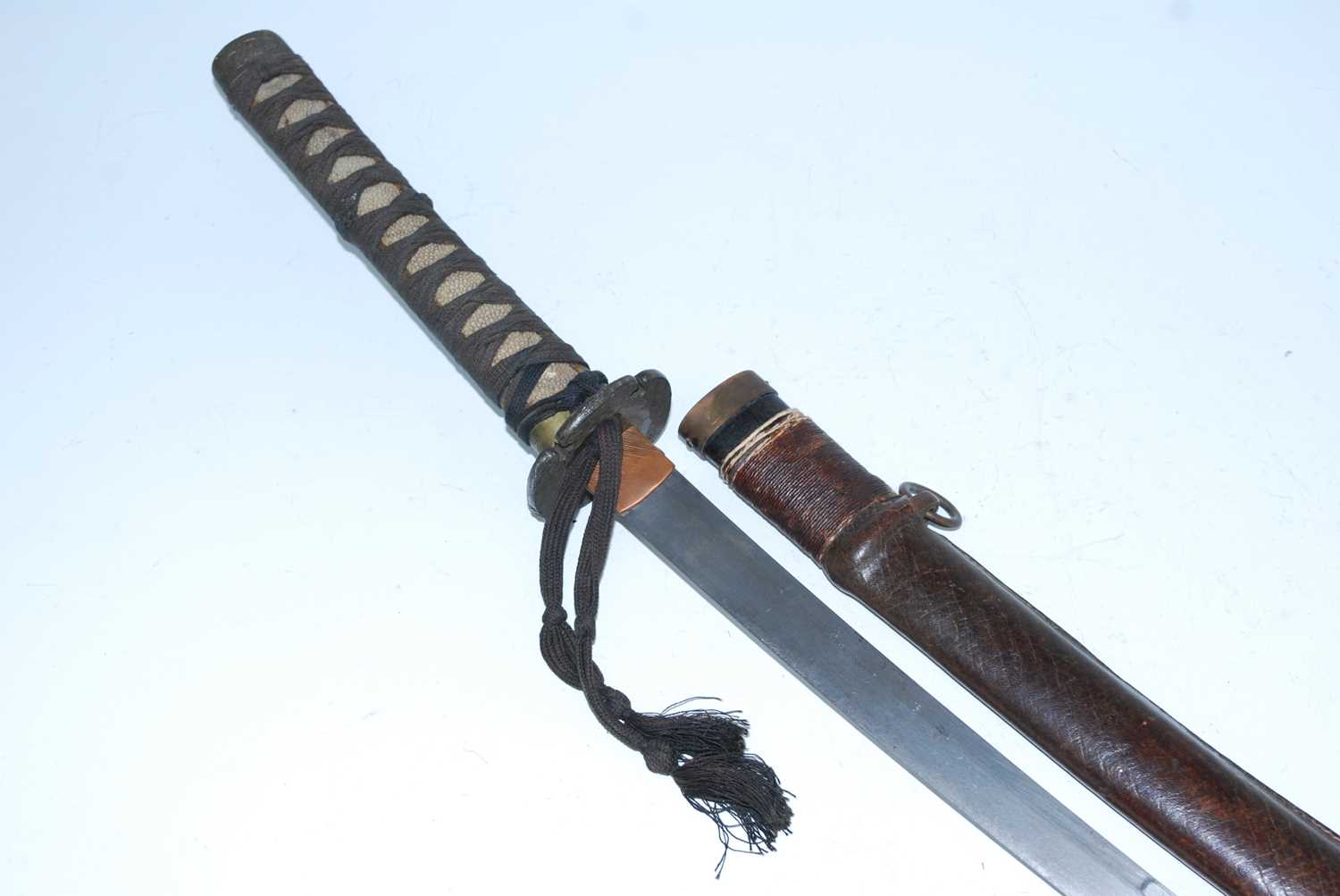 A Japanese Gendaito wakizashi, having a 54cm slightly curved blade with copper habaki, engraved