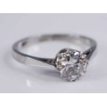 A white metal diamond solitaire ring, featuring a round brilliant cut diamond in a claw setting,