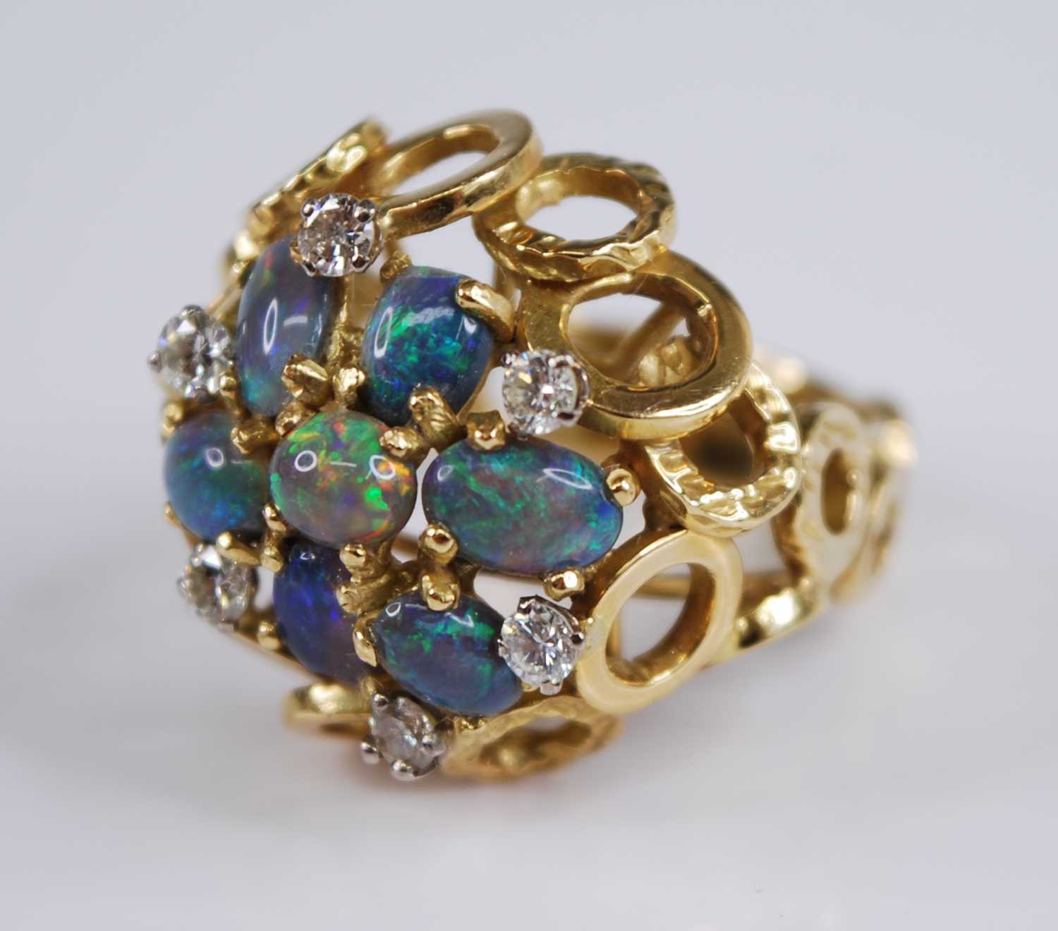 An 18ct yellow gold, opal and diamond bombe cluster ring, comprising seven opal cabochons