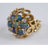 An 18ct yellow gold, opal and diamond bombe cluster ring, comprising seven opal cabochons