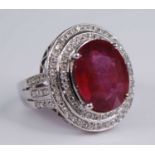 A contemporary 14ct white gold, ruby and diamond cluster ring, arranged as central four-claw set