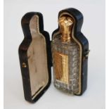 A mid-19th century cut glass and yellow metal mounted scent bottle, in fitted leather case, the