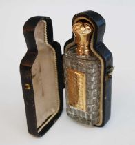 A mid-19th century cut glass and yellow metal mounted scent bottle, in fitted leather case, the