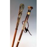 An early 20th century walking stick, having a carved horn handle with repousse decorated yellow