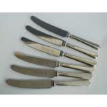 A set of eighteen Queen Elizabeth II silver handled table knives, having stainless steel blades,