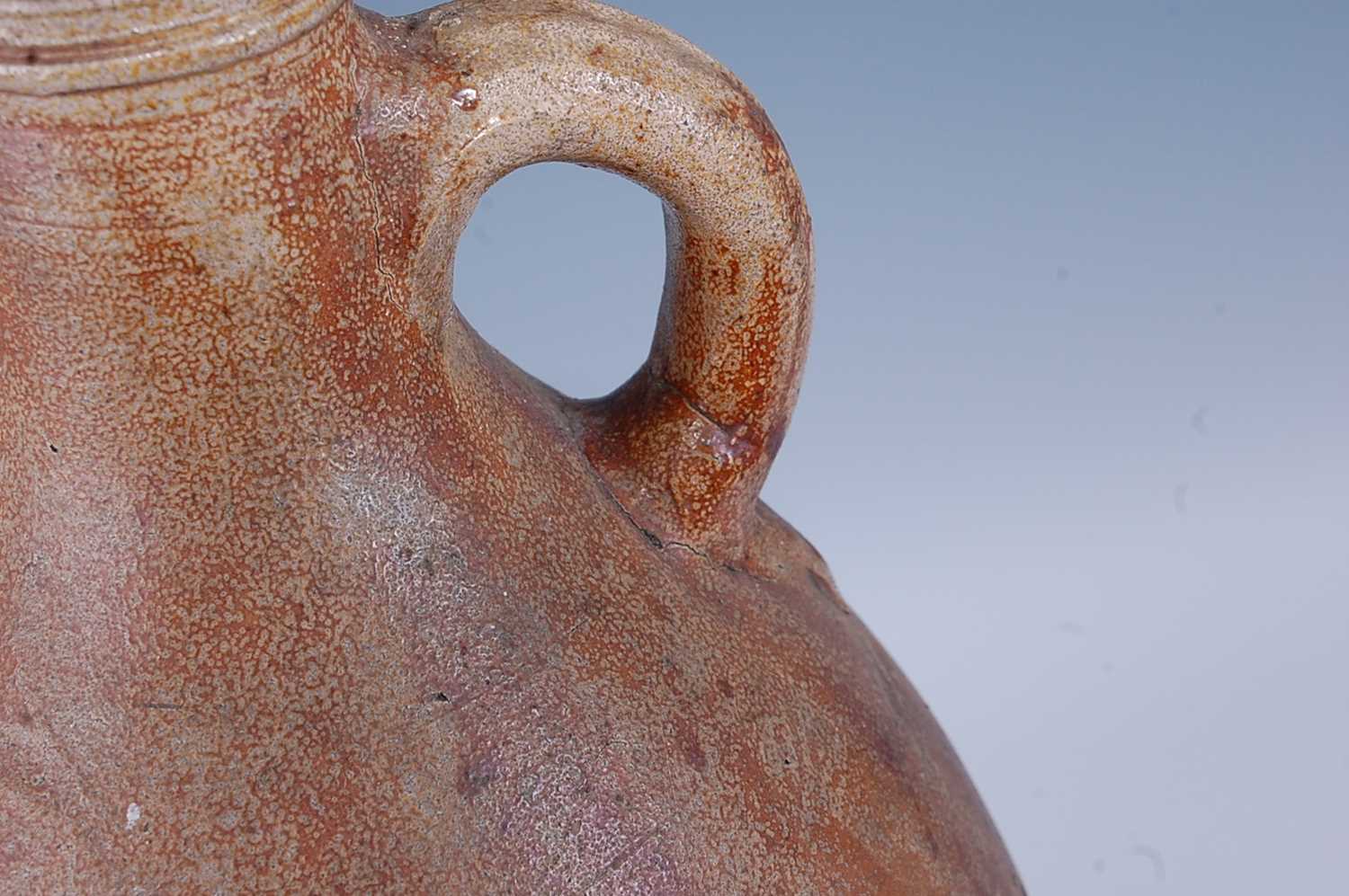 An early 18th century German salt glazed stoneware Bellarmine type flagon, of typical form, having a - Bild 5 aus 6