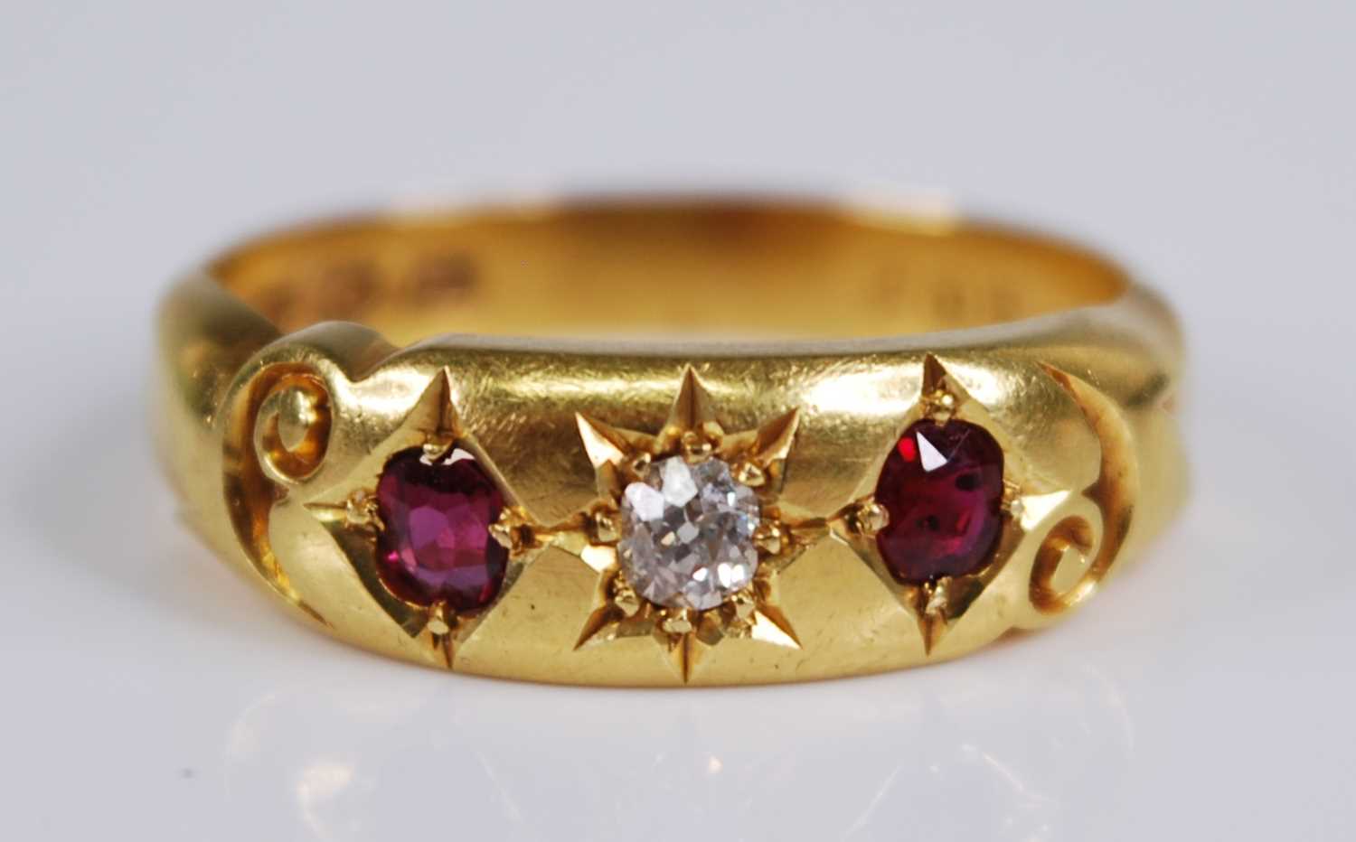 An Edwardian 18ct gold, ruby and diamond ring, the 'gypsy' set old round cut diamond weighing approx