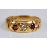 An Edwardian 18ct gold, ruby and diamond ring, the 'gypsy' set old round cut diamond weighing approx