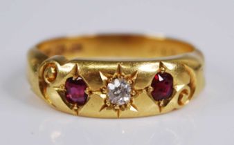 An Edwardian 18ct gold, ruby and diamond ring, the 'gypsy' set old round cut diamond weighing approx