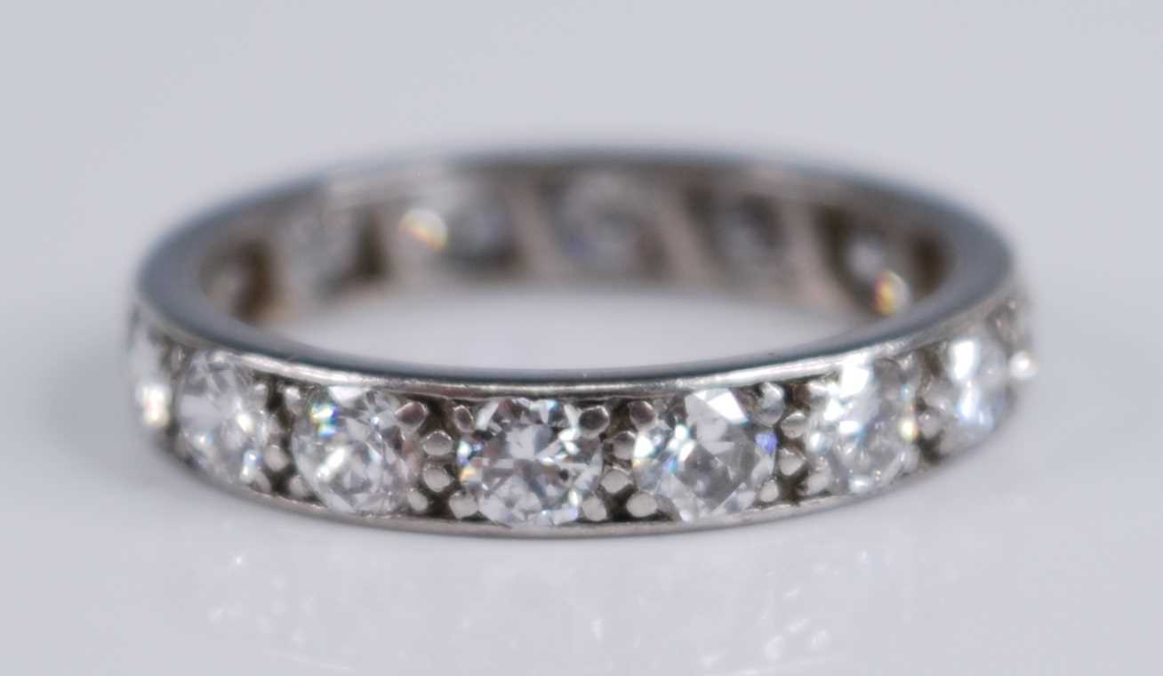 A white metal diamond full hoop eternity ring, grain set with 16 round brilliant cut diamonds,