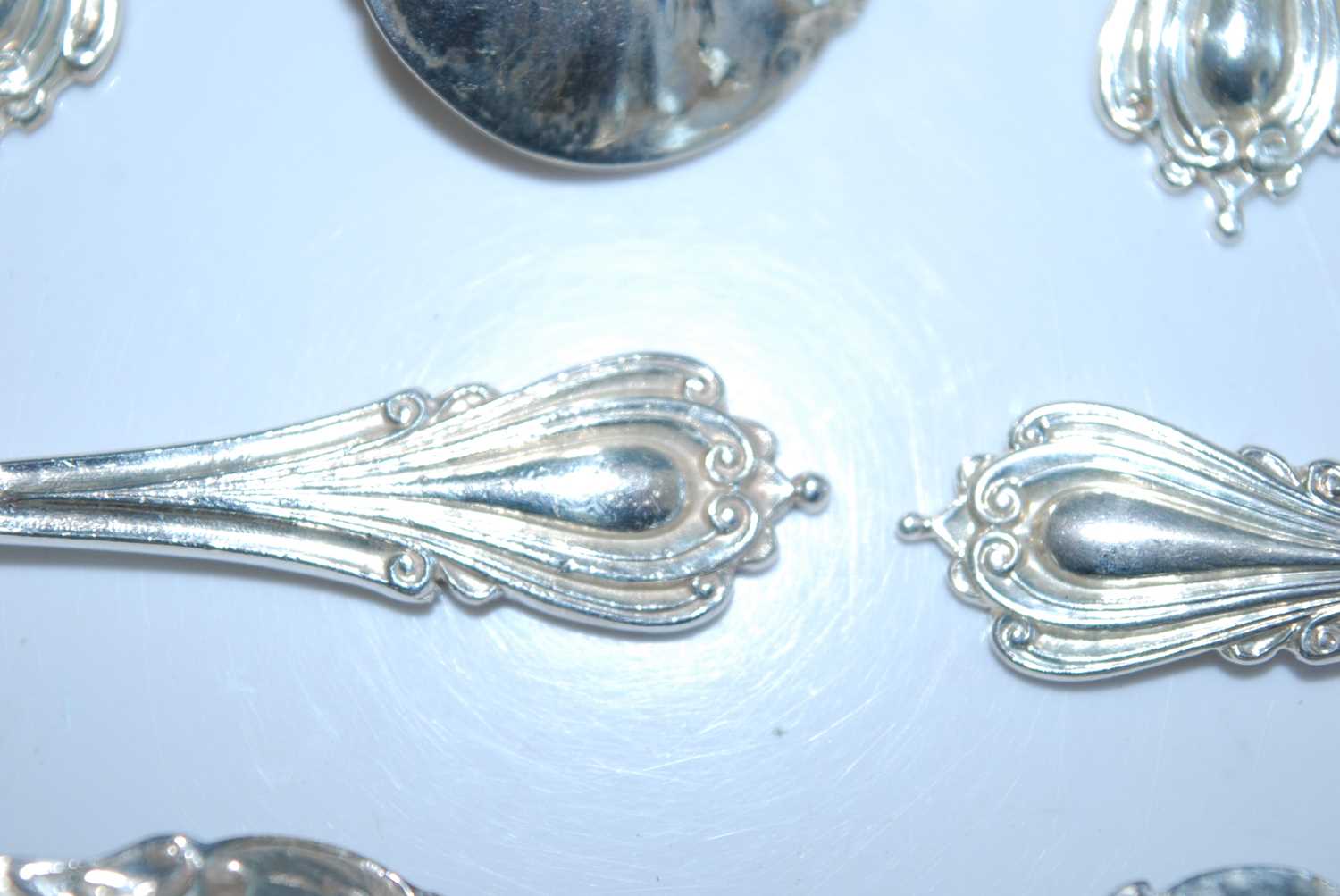 A matched set of fifteen early 20th century silver caddy spoons, the shaped scroll-edged bowls - Image 4 of 8