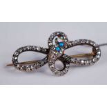 An Edwardian yellow metal diamond set snake brooch, comprising 63 graduated round cut diamonds,