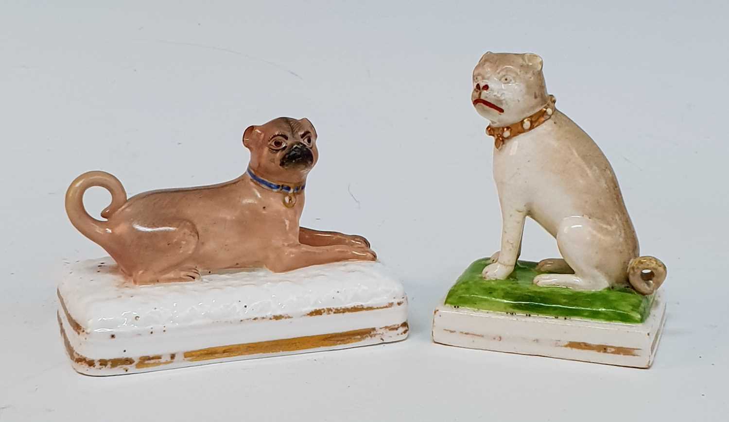 A circa 1830 Derby porcelain pug dog, modelled by Edward Keys, shown in seated pose, red enamel mark