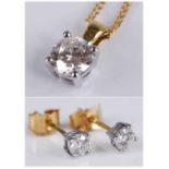 An 18ct yellow and white gold diamond pendant and earring set, the pendant featuring a round