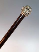 An early 20th century walking stick, the white metal handle in the form of the head of a Chinese man