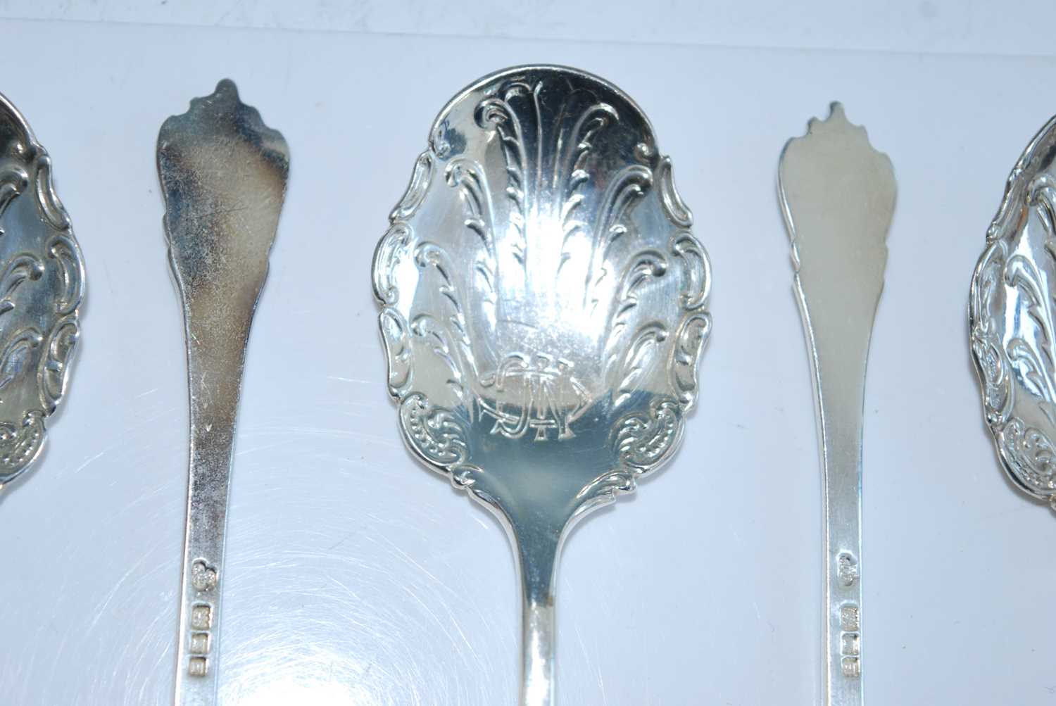 A matched set of fifteen early 20th century silver caddy spoons, the shaped scroll-edged bowls - Image 2 of 8