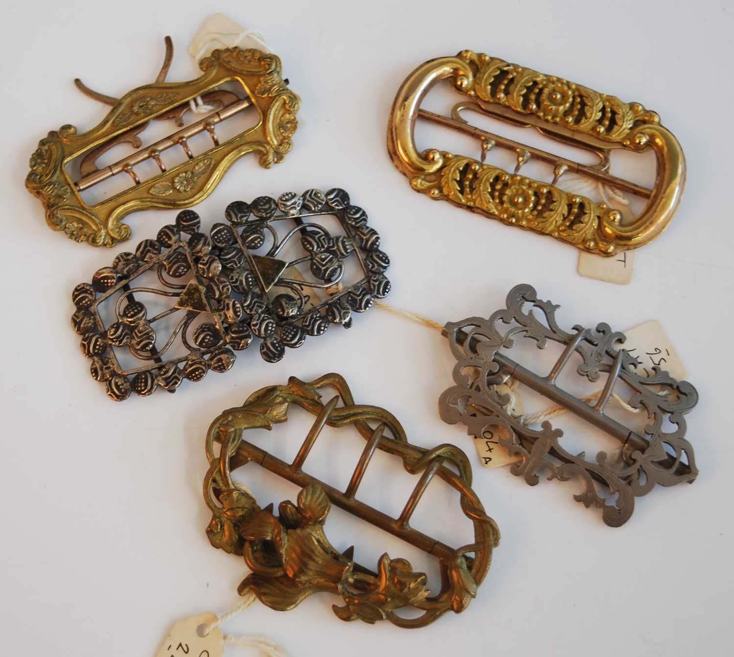 A collection of 19th century and later buckles, comprising a steel two-piece belt buckle, of