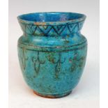 A Persian Kashan turquoise glazed earthenware jar, probably medieval, decorated with chevron and