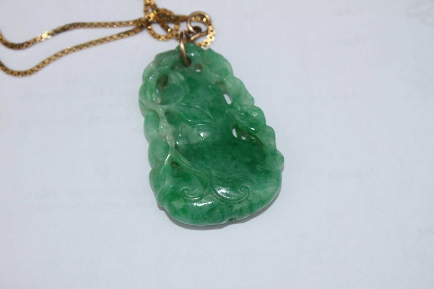 A Chinese carved green and celadon jade pendant, modelled as a gourd issuing leaves and foliage, h. - Image 7 of 7