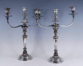 A pair of George III silver candlesticks, with matching plated three-light candelabra over, the