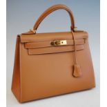 An Hermès tan leather Kelly bag, with gilt metal hardware including padlock to base and integral